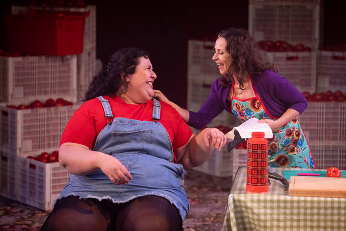 A mother and daughter share a laugh together.